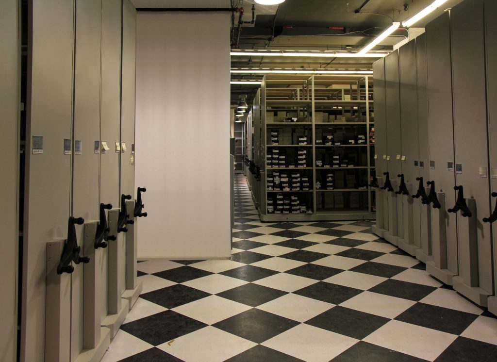 image of high density storage in a retail setting:  shelving and mechanical assist system